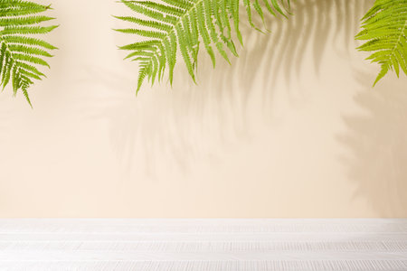 Template with empty table and wall with leaves shadow, perfect for product presentation and mockupの写真素材