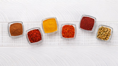 Various spices on the table, adding vibrant colors and rich aromas to the kitchenの写真素材