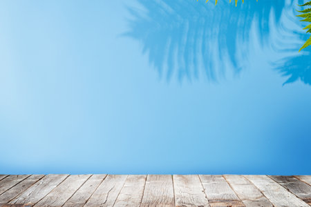 Template with empty table and wall with leaves shadow, perfect for product presentation and mockupの写真素材
