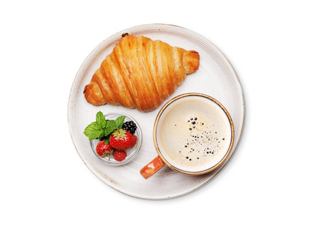 Coffee cup, berries and croissant. Flat lay. Isolated on white backgroundの写真素材