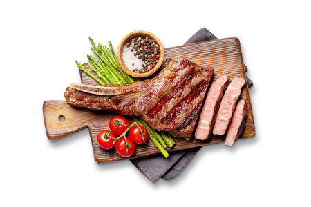 Medium rare grilled Tomahawk beef steak with asparagus. Flat lay. Isolated on white backgroundの写真素材
