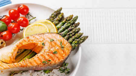 Grilled salmon steak over grilled asparagus, a delicious and healthy meal. With copy spaceの写真素材