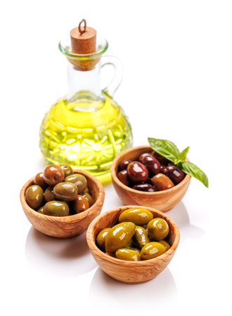 An assortment of various olives presented in a bowl, showing different colors, textures, and flavors. Isolated on white backgroundの写真素材