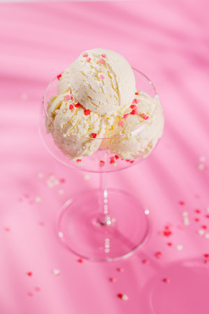 A charming ice cream treat adorned with heart-shaped decor on a soft pink background, symbolizing love and sweetness. Perfect for Valentine's Day celebrationsの写真素材