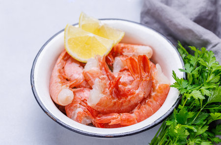 Fresh shrimps, accompanied by sprigs of fresh parsley and juicy lemon. Ideal beer snackの写真素材