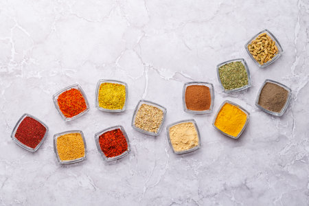 A vibrant assortment of various spices and herbs displayed together, showing their diverse colors...