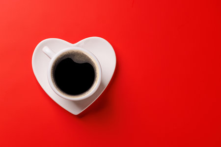 A charming coffee cup placed on a heart-shaped saucer, symbolizing love and warmth, perfect for Valentine's Day celebrations or romantic morningsの写真素材