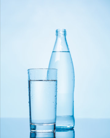 A simple and clear glass and bottle of pure water, showing freshness and hydration. Perfect for promoting health and simplicityの写真素材