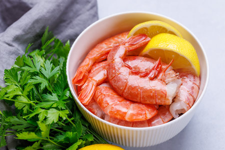 Fresh shrimps, accompanied by sprigs of fresh parsley and juicy lemon. Ideal beer snackの写真素材