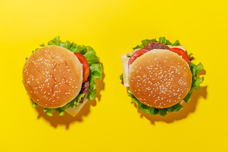 A vibrant photo showcasing juicy hamburgers, creating a fun and appetizing sceneの写真素材