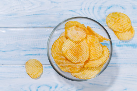 A vibrant photo showcasing a perfect beer snack potato chips, creating a fun and appetizing scene with copy spaceの写真素材