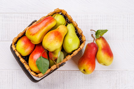 Autumn-themed food arrangement with ripe pears in a box, creating a cozy seasonal atmosphereの写真素材