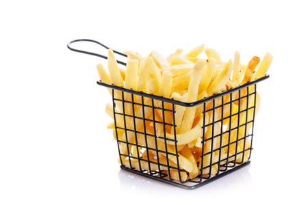 French fries isolated on a white background, perfect for a fast food or snack conceptの写真素材