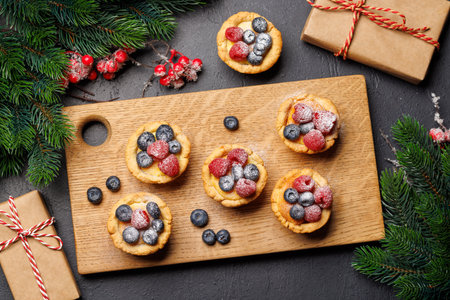 Festive delight: Christmas cupcakes adorned with berries. Flat layの写真素材