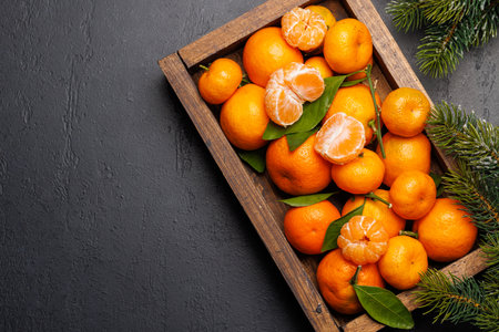 Festive citrus joy: Tangerines in a holiday-themed box, flat lay with copy spaceの写真素材