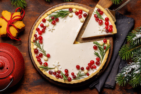 Festive indulgence: Christmas cake adorned with berries and rosemary. Flat layの写真素材