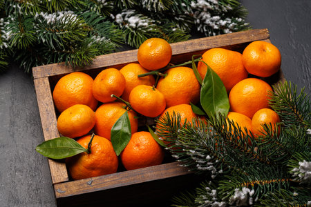 Festive citrus joy: Tangerines in a holiday-themed box, flat layの写真素材