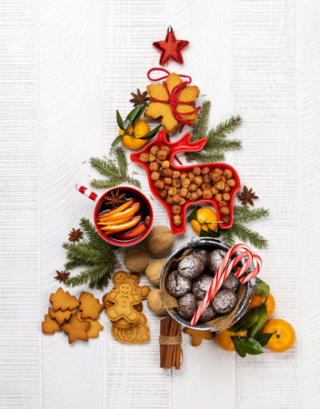 Christmas tree-shaped with cookies, surrounded by assorted nuts and festive decor, creating a cozy holiday ambianceの写真素材