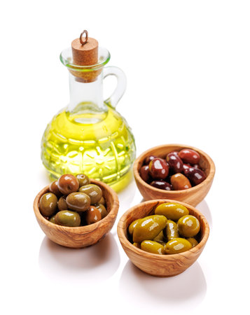 An assortment of various olives presented in a bowl, showing different colors, textures, and flavors. Isolated on white backgroundの写真素材