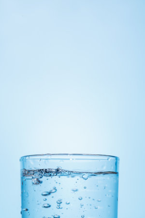 A simple and clear glass of pure water, showing freshness and hydration. Perfect for promoting health and simplicityの写真素材