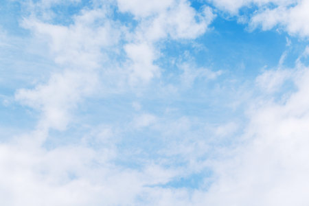 Majestic sunny sky with scattered small clouds, creating a bright and serene atmosphere