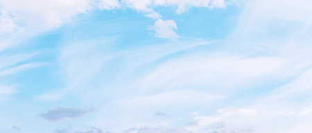 Majestic sunny sky with scattered small clouds, creating a bright and serene atmosphereの写真素材