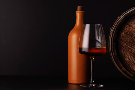 A glass of wine set against a dramatic dark background.の写真素材