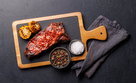 A perfectly cooked striploin steak with a juicy, tender texture on a dark background. A gourmet meal for steak and wine loversの写真素材