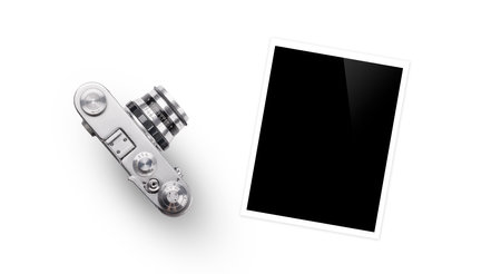 Travel-themed flat lay with blank photo card and camera, arranged creatively on white backgroundの写真素材