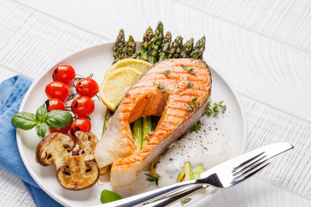 Grilled salmon steak over grilled asparagus, a delicious and healthy mealの写真素材