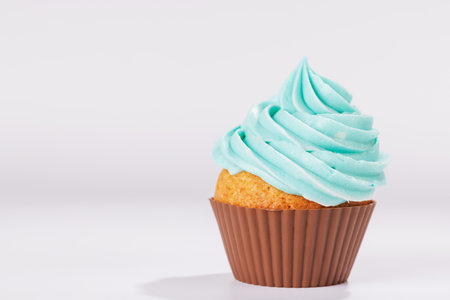 Festive cupcake topped with swirled frosting. Perfect for birthday celebrations or special occasionsの写真素材