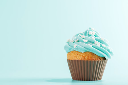 Festive cupcake topped with swirled frosting. Perfect for birthday celebrations or special occasions with copy spaceの写真素材