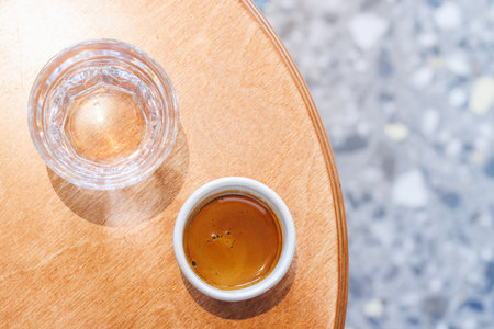Freshly brewed espresso served in a small cup on a table, capturing the rich aroma and bold flavor of a perfect coffee momentの写真素材