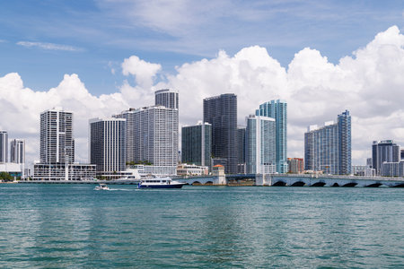 Modern skyline of Miami with towering skyscrapers, tropical vibe, and waterfront views under a sunny skyの写真素材
