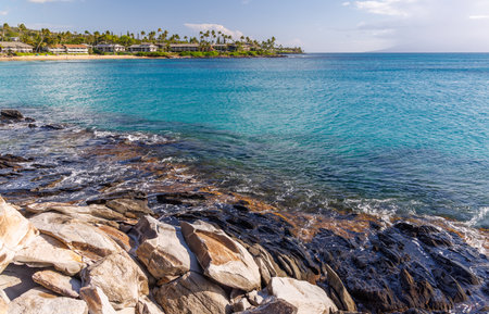 Beautiful Maui landscape in Hawaii featuring a sandy beach, turquoise sea, and lush greeneryの写真素材
