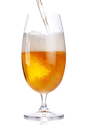 A glass of beer with a golden hue and frothy head, isolated on a clean white background. A refreshing concept for brewing, pubs, and beverage presentationsの写真素材