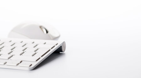 Keyboard and mouse on a white background with ample copy space for text or design elementsの写真素材