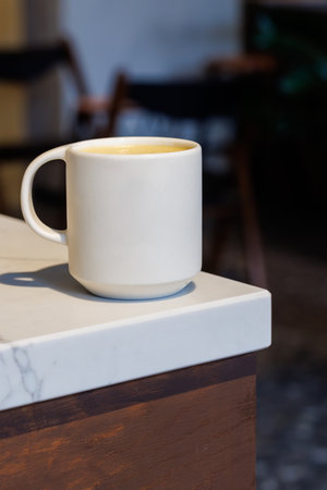 Warm cappuccino in a cup with latte art on top, symbolizing love and comfort in every sipの写真素材
