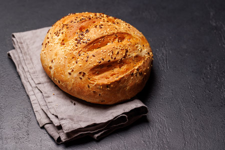 A loaf of freshly baked homemade bread with a golden crust and soft, airy texture, exuding warmth and inviting aroma, perfect for any mealの写真素材