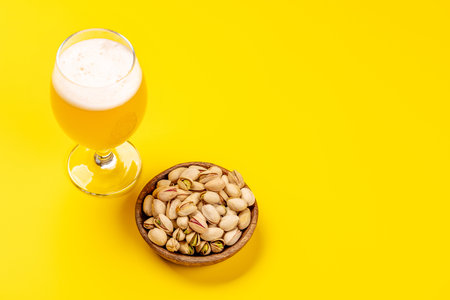 Fresh pistachios, showing their vibrant green color and unique texture, perfect for snacking or garnishing dishes paired with beerの写真素材