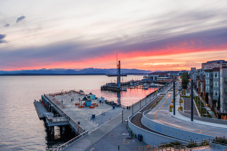 Seattle skyline during sunset with vibrant sky colors and city lights starting to glowの写真素材