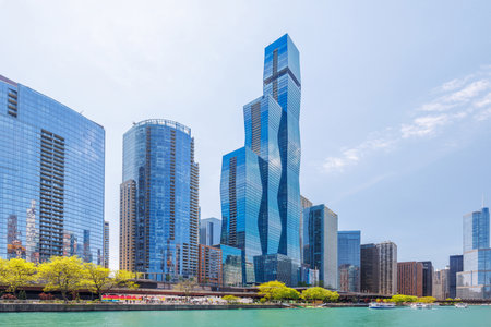Vibrant sunny view of Chicago downtown skyline under a blue sky, highlighting the city iconic architecture and urban energyの写真素材