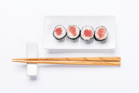Sushi maki beautifully arranged on plate, featuring fresh ingredients and vibrant colors, on a clean white backgroundの写真素材