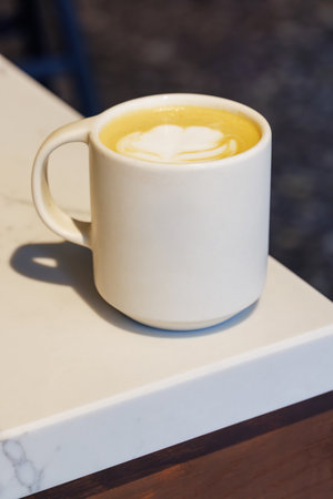 Warm cappuccino in a cup with latte art on top, symbolizing love and comfort in every sip