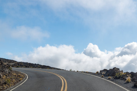 Mountain road above the clouds with scenic views and soft lightの写真素材