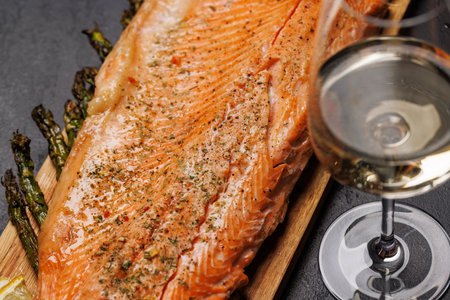 Grilled salmon fillets and asparagus on wooden board