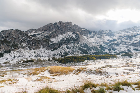 Snow-covered mountains in Montenegro with moody sky and scenic winter landscapeの写真素材