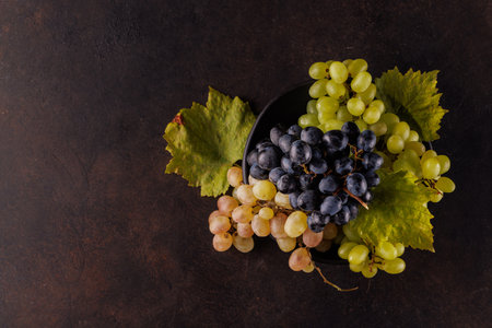 Fresh grapes bowl on a stone table with copy space. Flat layの写真素材