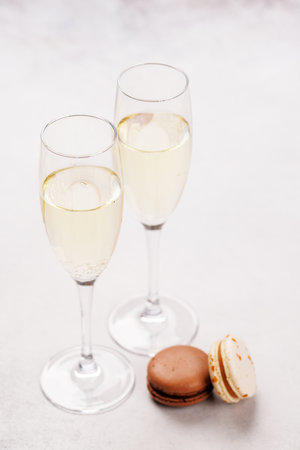 A luxurious pairing of champagne and delicate macaroons, creating an elegant and indulgent treat. Perfect for celebrations, special occasions, and gourmet experiencesの写真素材