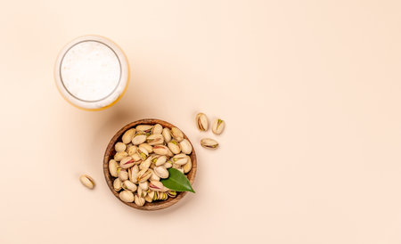 Fresh pistachios, showing their vibrant green color and unique texture, perfect for snacking or garnishing dishes paired with beerの写真素材